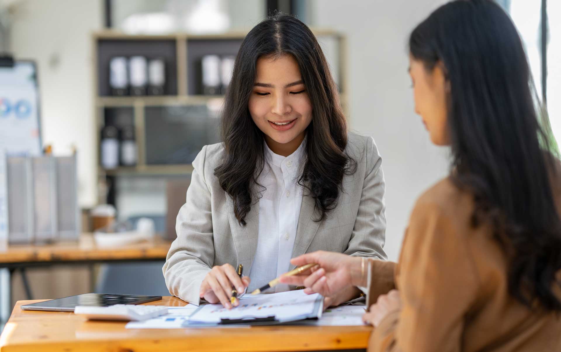 two girls looking at taxes