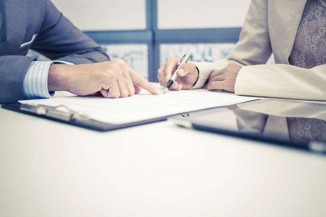 accountant pointing where to sign