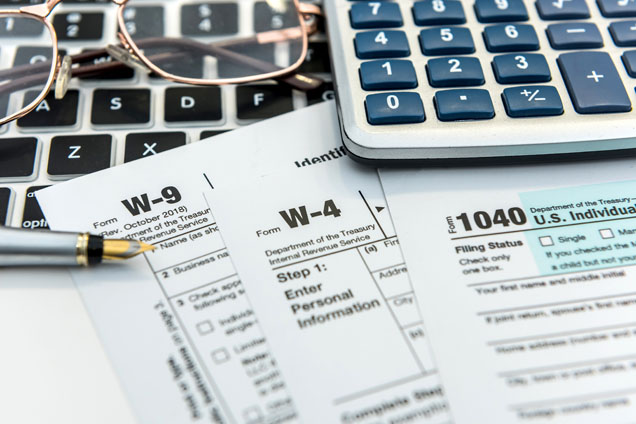 calculator, keyboard and tax forms
